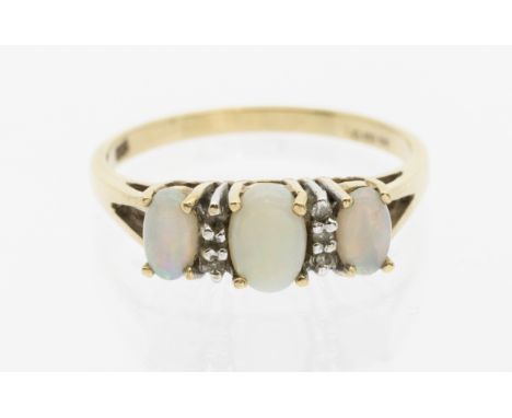 An opal and 9ct yellow gold three stone ring, comprising three graduated oval opals with small diamond accents, size L, total