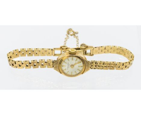A ladies vintage 9ct gold cased wristwatch, comprising a silvered dial with baton markers, hallmarked case aprox 15mm, to a 9