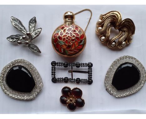 Two late 20th Century Kenzo brooches, one silver tone in the form of leaves and berries and the other in a gold tone in the f