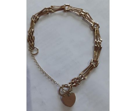 A 9ct gold gate link bracelet with safety chain and heart-shaped padlock clasp, 5.42gLocation: 
