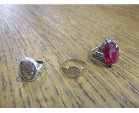 An 8ct gold and silver set dress ring, large central oval cut red paste stone surround a marcasites (two stones deficient) a 