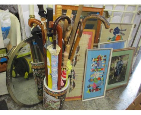 A mixed lot to include walking sticks and umbrellas in an Oriental stick stand together with mixed pictures and mirrorsLocati