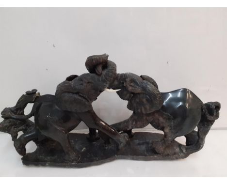 A stone model of two fighting elephants, 26cm high x 52cm wideLocation: A4B 