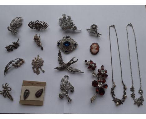 A collection of vintage silver, marcasite and paste brooches to include a small cameo brooch stamped 800 to the mount and oth