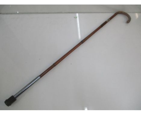 An Edwardian sword stick with a bamboo shaft and crook handle and silver band 