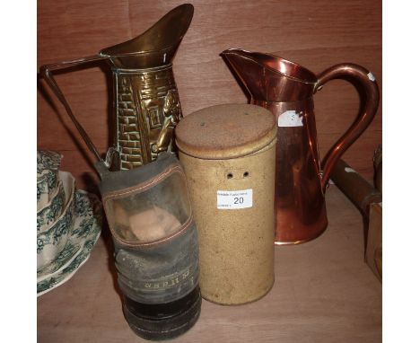 Copper jug and a brass jug with relief moulded design and a WWII period gas mask in tin flask