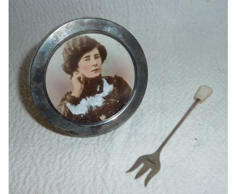 Small circular silver photo frame and silver pickle fork