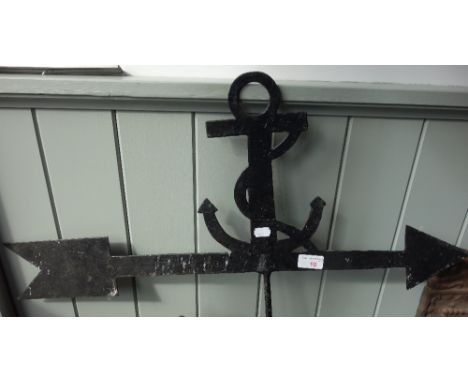A WEATHER VANE decorated with an anchor and a pair of iron fire dogs