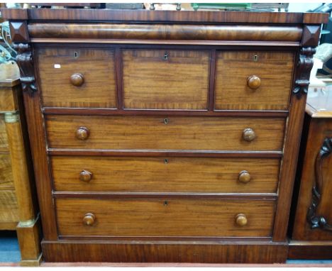 A VICTORIAN MAHOGANY "SCOTCH" CHEST OF DRAWERS, with carved corbels and shaped frieze drawer, 127cm wide
