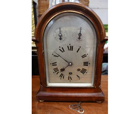 A LARGE BRACKET CLOCK with silver dial and chiming movement, 34cm high (key and pendulum in office)
