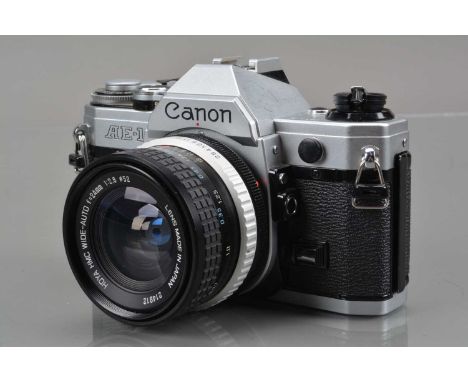 A Canon AE-1 SLR Camera, chrome, shutter working, meter responsive, self timer working, body G, crack to bottom of battery do