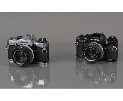 Two Olympus OM-10 Cameras, one chrome, shutter working, meter responsive, self timer working, body G, one black quartz, shutt