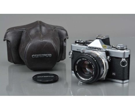 An Olympus OM-2n MD SLR Camera, shutter working, meter responsive, shutter responsive in auto, self timer working, body G-VG,