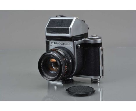 A Pentacon Six TL Medium Format Camera, shutter sluggish in one second, self timer stutters/sticks, body G, some lifting to l