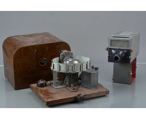 A Shop Advertising Slide Projector, housed in wood patterned metal shell with rotating fourteen slot metal slide carousel, po