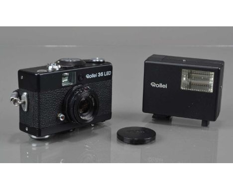 A Rollei 35 LED Compact Camera, made in Singapore, black, shutter working, meter responsive, top plate lifting from camera bo