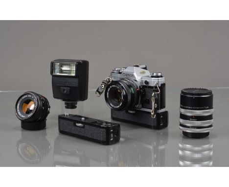 A Canon AE-1 SLR Camera, shutter working, meter responsive, self timer working, body G-VG, with two FD 50mm f/1.8 lenses, bar