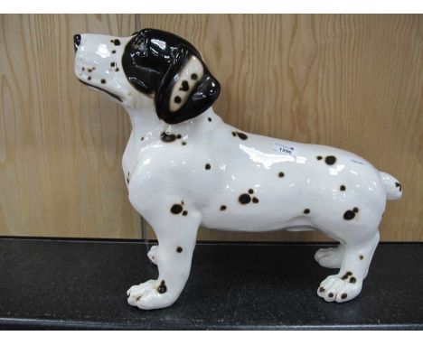 A large ceramic black and white spotted dog figurine 38cm h.