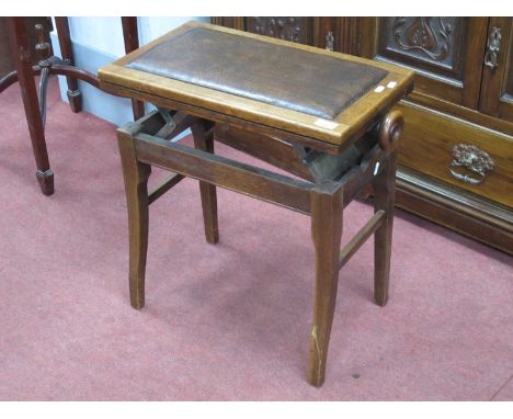 An early 1900s adjustable height oak organ/ piano stool with mechanical operation by side knobs 60cm w.underneath the seat ne