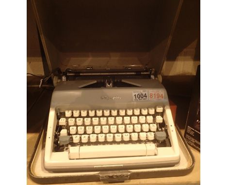 A cased vintage Olympia typewriter.  Not available for in-house P&amp;P, contact Paul O'Hea at Mailboxes on 01925 659133 