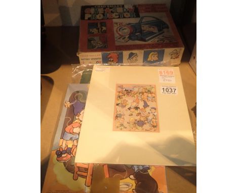 A Chad Valley boxed Give A Show projector, three childrens wooden jigsaws and a Noddy and Big Ears signed print. Not availabl