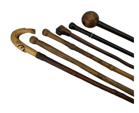 Group of vintage walking hardwood walking sticks & Knobkerrie, including a hand carved example, ebonised walking cane with wh