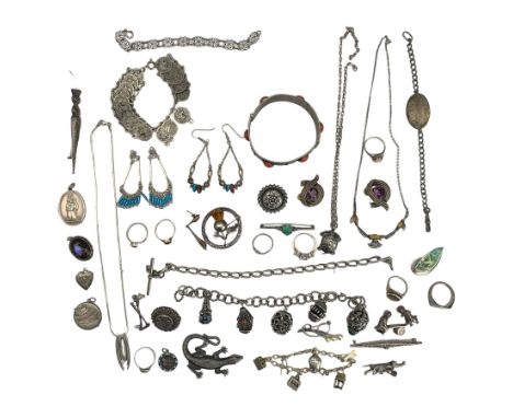 Collection of silver and white metal jewellery, including a silver turtle compass charm, two Scottish brooches, charm bracele