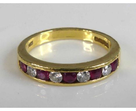 An 18ct yellow gold ruby and diamond half hoop ring featuring 5 rubies alternating with 4 round brilliant cut diamonds all in