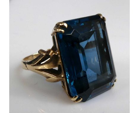 A yellow metal synthetic spinel dress ring, featuring a rectangular cut synthetic spinel in a double four-claw setting, synth