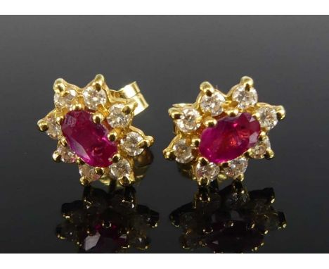 A pair of 18ct yellow gold, ruby and diamond oval cluster earrings, each featuring a centre ruby within a border of eight rou