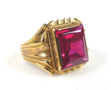 A yellow metal synthetic ruby dress ring, the synthetic ruby measuring approx 12.25 x 10.2 x 5.5mm, weight estimated as 7.34 