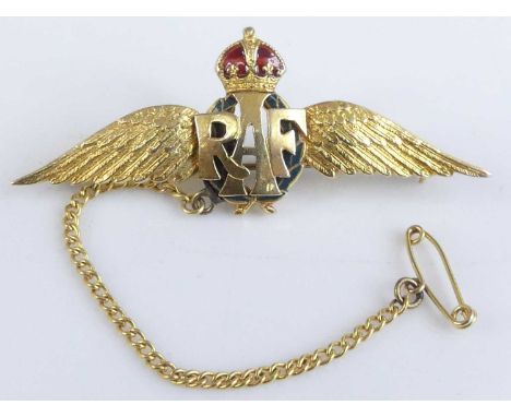 A yellow metal RAF wings brooch, the crown set with red enamel, with safety chain and steel pin, unmarked but tests as approx