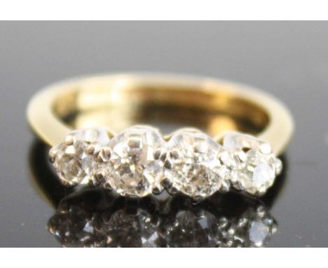 An 18ct yellow and white gold diamond four-stone ring, comprising four graduated Old European cut diamonds in claw settings, 