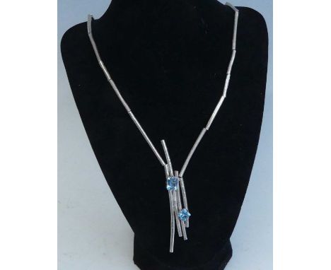 A sterling silver contemporary abstract blue topaz necklace by Kelvin J. Birk, comprising a series of 3mm wide textured tubul