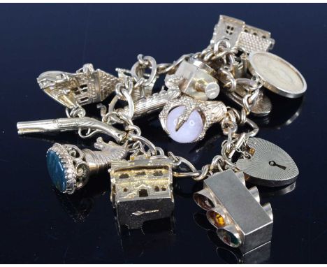 A 9ct gold curblink bracelet, containing a good selection of principally 9ct gold charms to include traffic light, crooked ho