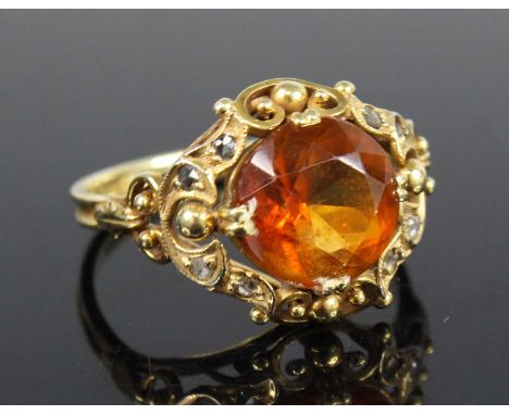 A yellow metal, citrine and diamond ring, featuring a round faceted citrine within a scrollwork mount set with eight rose cut