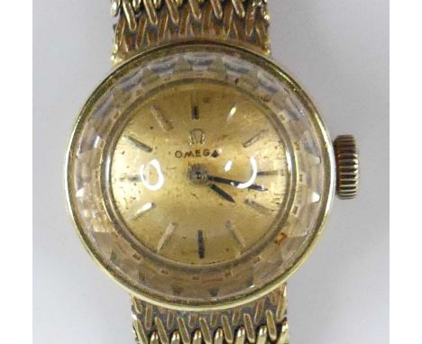 A lady's Omega 18ct gold cased bracelet watch, having a signed gilded dial with baton markers, manual wind movement, case dia