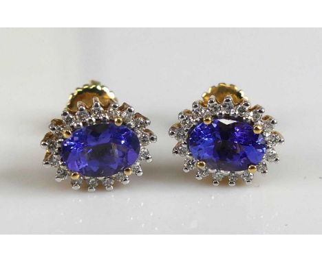 A pair of 18ct yellow gold, tanzanite and diamond oval cluster earrings, each comprising a centre oval tanzanite within a bor