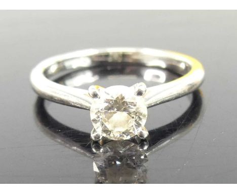 A platinum diamond solitaire ring, comprising a round brilliant cut diamond in a four-claw setting, diamond dimensions approx