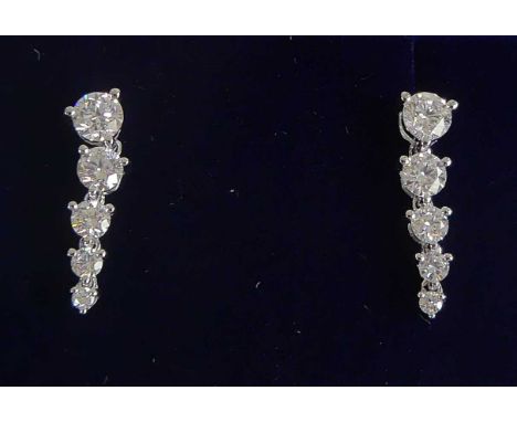 A pair of 18ct white gold diamond drop earrings, each featuring five graduated round brilliant cut diamonds in claw settings,