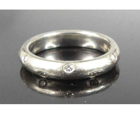 A Michael Birnie of Bury St Edmunds platinum diamond set eternity ring arranged as 12 brilliants to a faceted band, total dia