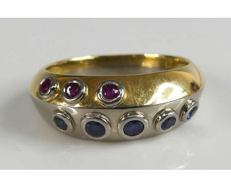 An 18ct yellow and white gold, sapphire and ruby dress ring, featuring five graduated round sapphires in the white section an