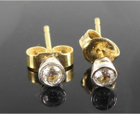 A pair of 18ct yellow and white gold diamond single stone stud earrings, each with a round brilliant cut diamond in a claw se