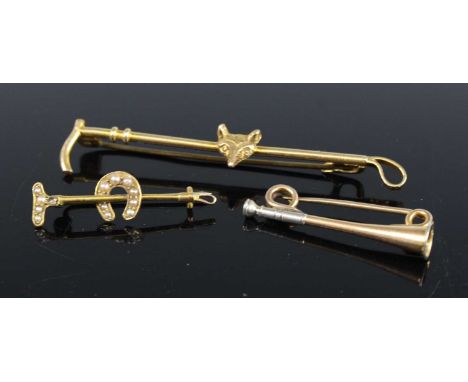 A yellow metal brooch fashioned as a hunting horn, on safety pin fitting, unmarked but tests as 15ct gold, 3cm; together with