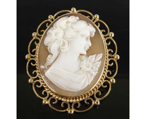 A Victorian style carved shell cameo brooch depicting profile portrait of a maiden, with flower in her hair, 34 x 26mm, in 9c