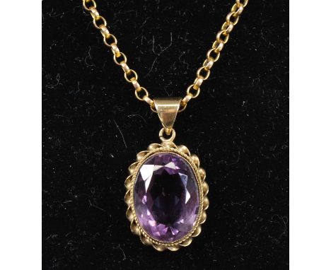 A 9ct yellow gold amethyst pendant, featuring an oval faceted amethyst within a ropetwist surround, attached to an oval belch