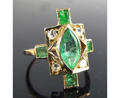 A yellow metal Art Deco style emerald and diamond panel ring, featuring a centre marquise cut emerald with four rose cut diam