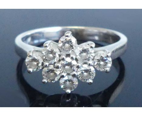 An 18ct white gold diamond navette shaped cluster ring, comprising nine round brilliant cut diamonds in claw settings, diamon