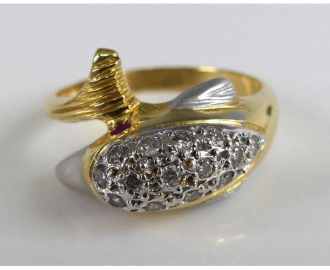 A yellow and white metal dolphin crossover style dress ring, the head pavé set with 14 round brilliant cut diamonds with two 