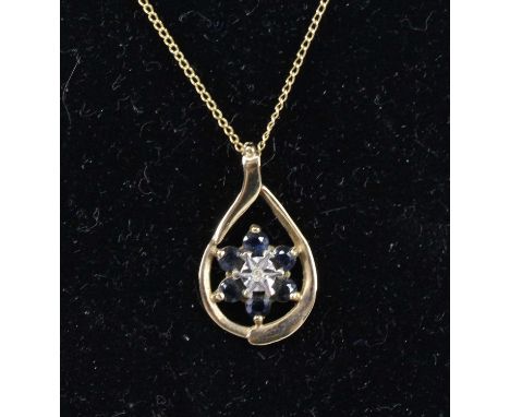 A 9ct yellow gold, sapphire and diamond cluster pendant, being an oval surround comprising a centre 1.3mm single cut diamond 